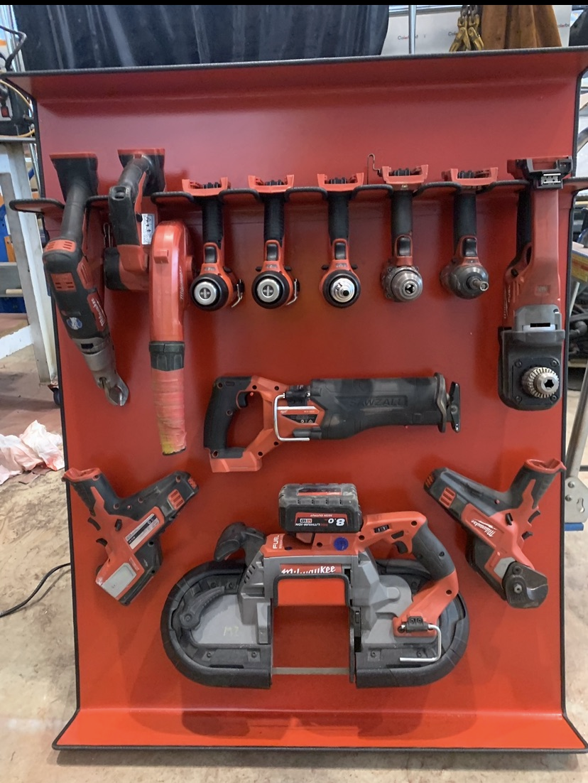 Custom red steel mobile tool board with organised Milwaukee power tools
