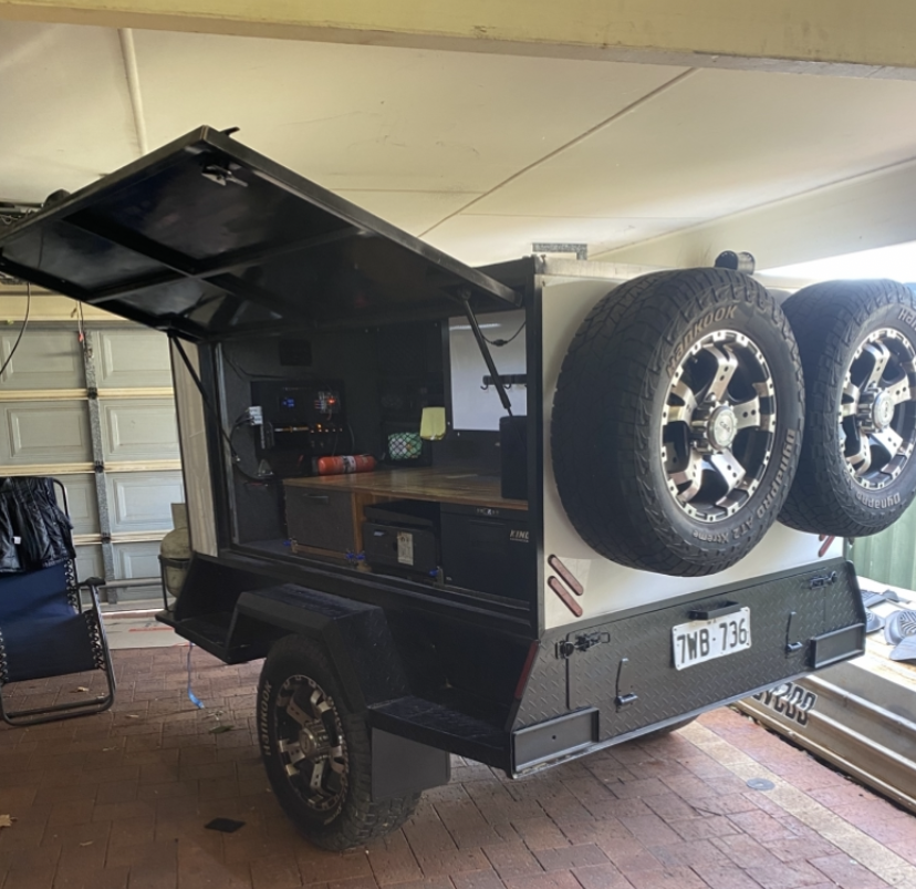 Finished custom off-road trailer with dual spare wheels and gullwing door