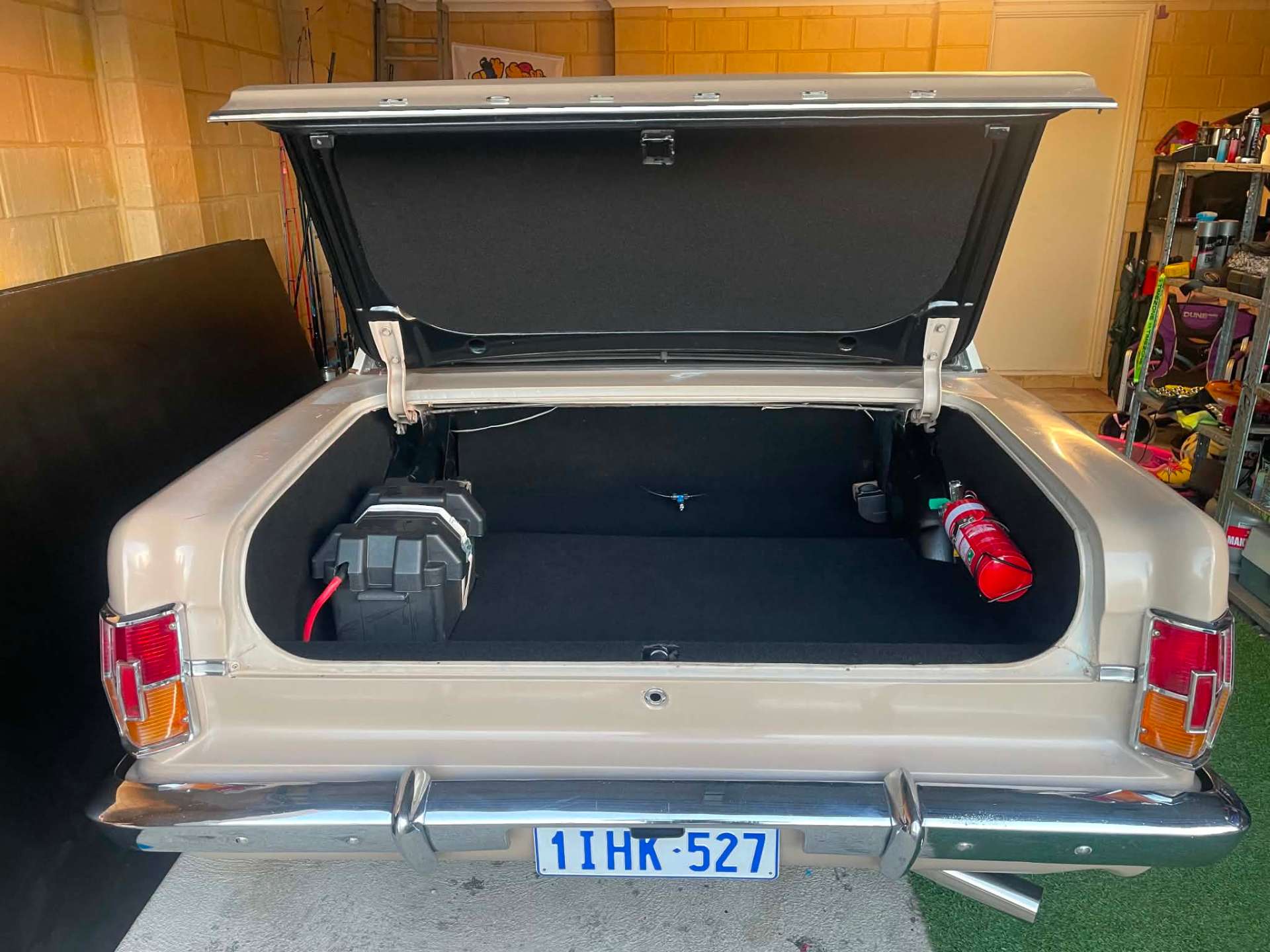 Custom fabricated boot floor and battery setup in a classic Australian car