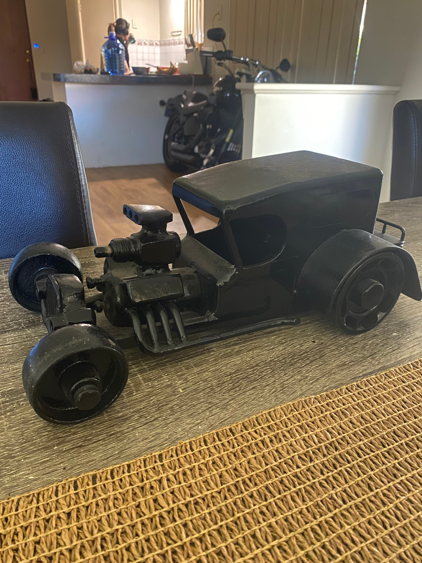 Custom fabricated matte black hot rod coupe sculpture with blown 350 engine, built from workshop off-cuts