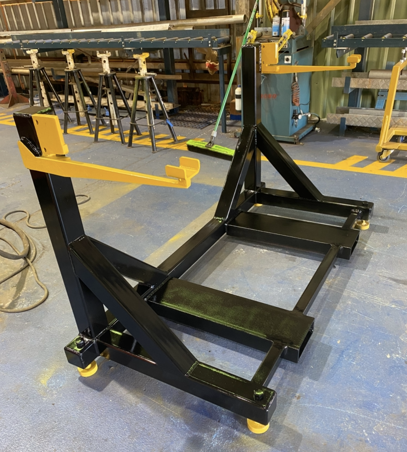 Heavy duty conveyor stand with yellow lifting arms and black powder coated frame