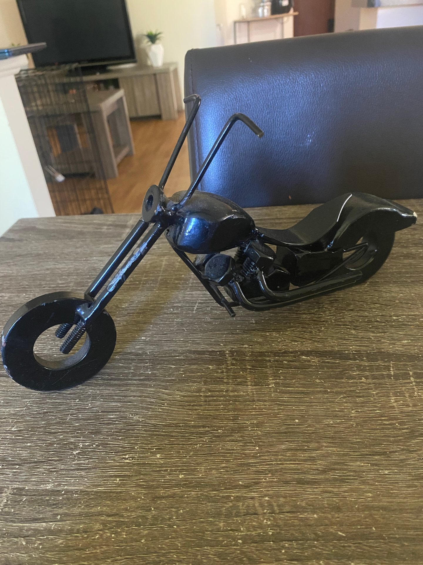Hand fabricated black chopper motorcycle sculpture built from nuts, bolts and washers